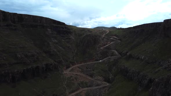 Drone shot of Drakensberg in South Africa - drone is flying up Sani Pass into Lesotho. Snippet could alt