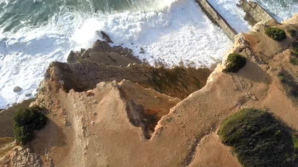 aerial fly up over the cliff and waves, sesimbra alt
