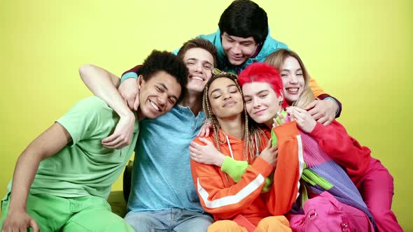 Young colorful people embracing each other