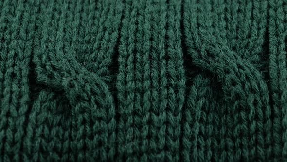 Pigtails on Green Knitwear Fabric Texture. Machine Knitting Texture Macro Snapshot.