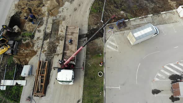 Aerial view of the repair road. Pipe laying, view from height. alt