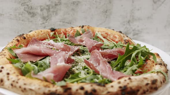 Delicious Pizza with Prosciutto Parma Ham Arugula Salad Rocket with Ingredients alt