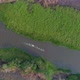 Drone aerial of two boats on a river in Pantanal during wildfires, black burnt landscape - VideoHive Item for Sale