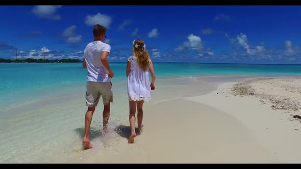 Two lovers sunbathing on relaxing resort beach time by shallow ocean with white sandy background of  alt