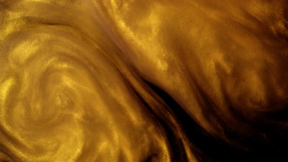 Golden Ink or Dust Creating Abstract Cloud Formations. Art Backgrounds alt