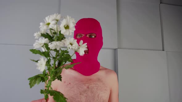 Anonymous Shirtless Man in Balaclava with Flowers alt