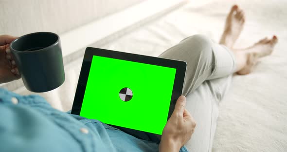 Woman Holding Greenscreen Tablet