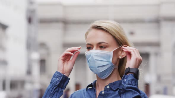 Side view of Caucasian woman wearing a coronavirus Covid19 mask alt