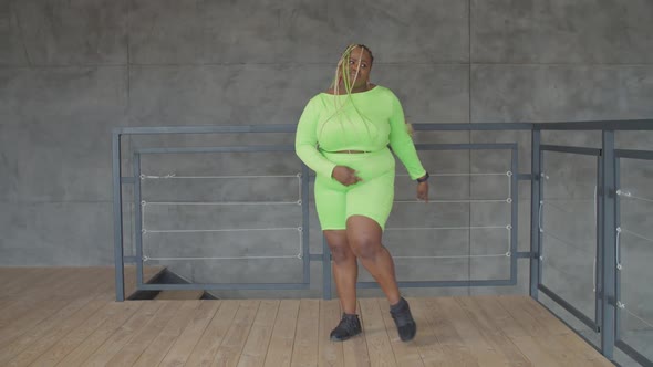 Happy Overweight African Female Dancing at Home alt
