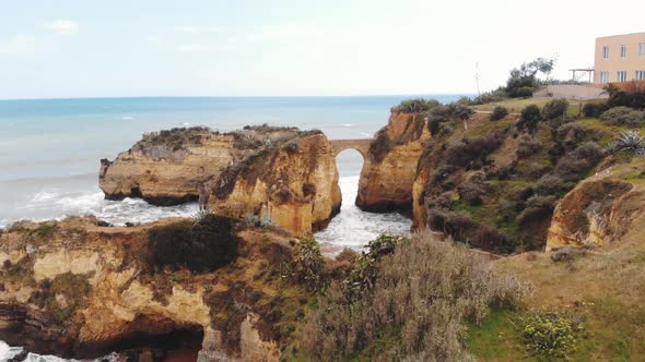 Arched Primitive stone Bridge At Student Beach In Lagos, Algarve, Portugal alt