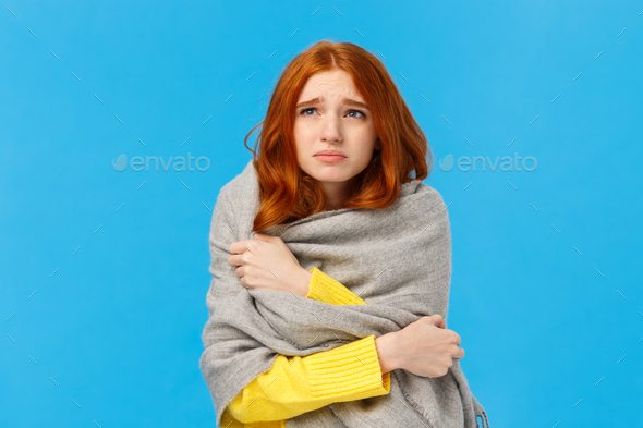 Girl sitting dormitory with broken heater, wrapping herself with warm scarf, looking upset and