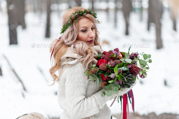 A young girl of Slavic appearance with a wreath of wildflowers. - Stock Photo - Images