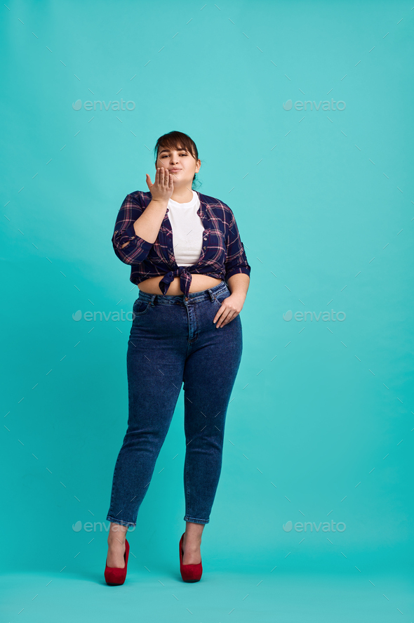 Overweight woman poses in studio, body positive Stock Photo by NomadSoul1