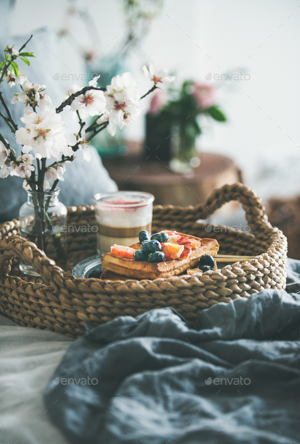 Waffles with blood orange and blueberries, rose latte coffee and blooming flower - Stock Photo - Images