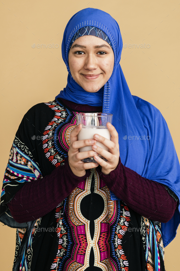 Muslim woman with a glass of soy milk Stock Photo by Rawpixel PhotoDune