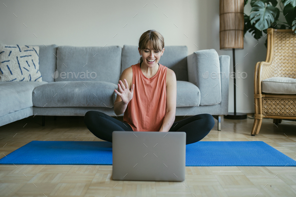Woman taking an online yoga class during coronavirus quarantine