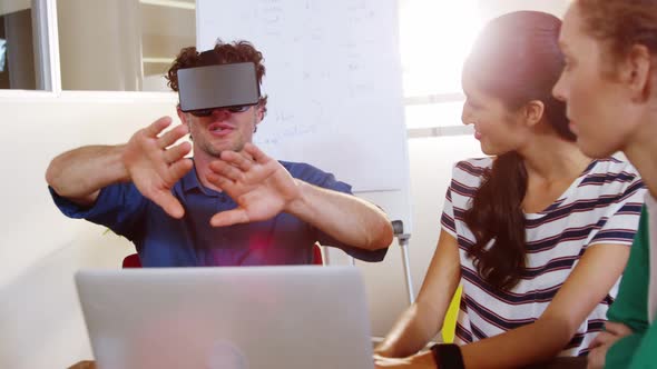 Businessman using virtual reality headset in meeting alt