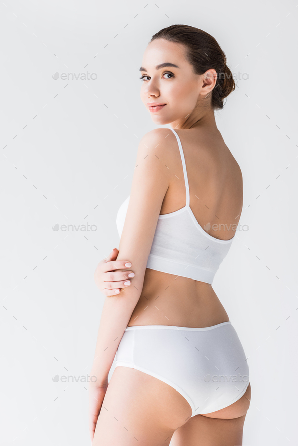 Foto de Young pretty woman on isilated background in white underwear.  Beautiful girl in perfectly clean underclothes do Stock