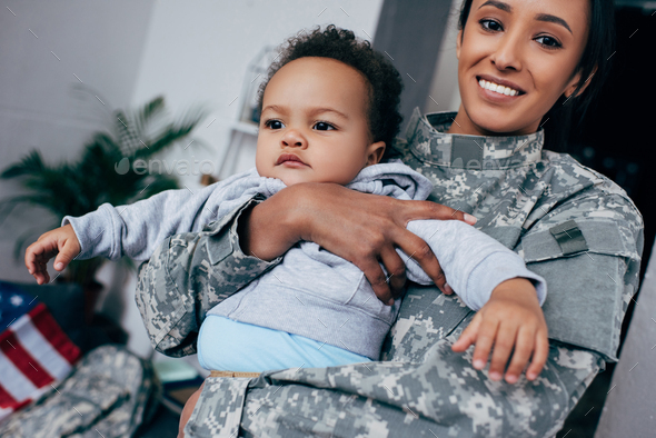 african american mother in military uniform with baby boy at home Stock ...