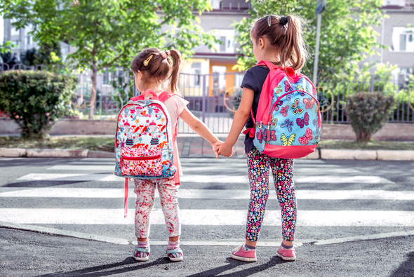 Children Go To School Happy Students With School Backpacks And Holding Hands Together Stock Photo By Puhimec