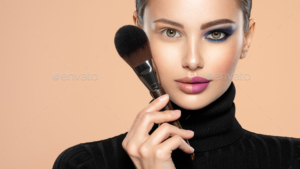 One half face of a beautiful white woman with bright makeup and the other  is natural. Stock Photo by valuavitaly