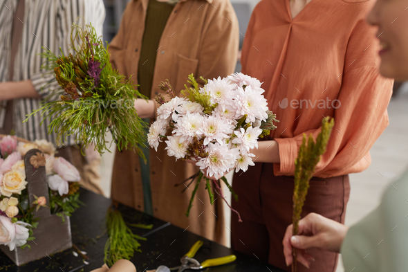 People Creating Flower Compositions in Florists Workshop
