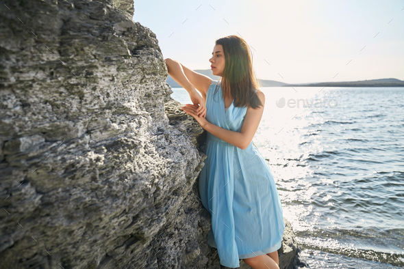 Pleasant woman leaning on rock near Dniester river Stock Photo by ...