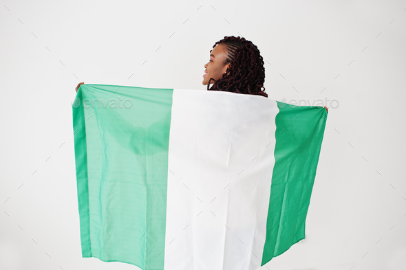 Nigerian woman hold Nigeria flag isolated on white wall. - Stock Photo - Images
