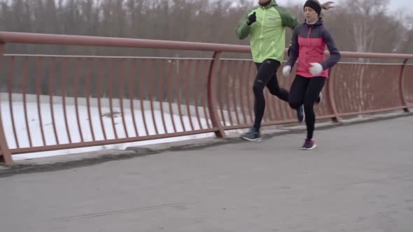 Couple Running Across Bridge alt