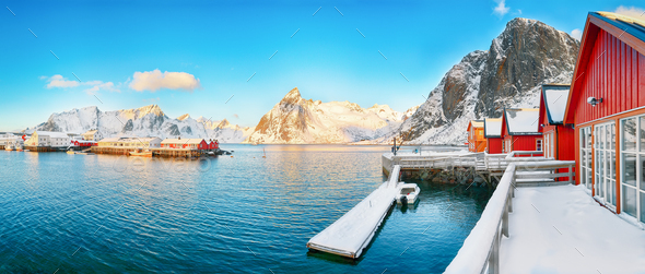Traditional Norwegian red wooden houses (rorbuer) on the shore of Reinefjorden near Hamnoy village. - Stock Photo - Images