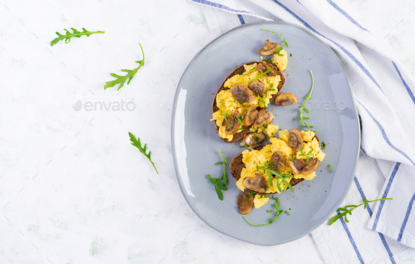 Scrambled eggs and fried mushrooms on bread - Stock Photo - Images