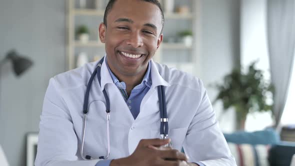 Smiling Positive AfricanAmerican Doctor At Work Looking at Camera alt
