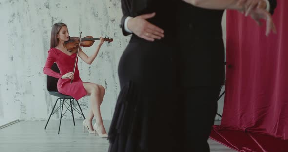 Two Elegant Girls Playing the Violin Couple of Dancers Performs Ballroom Dance alt