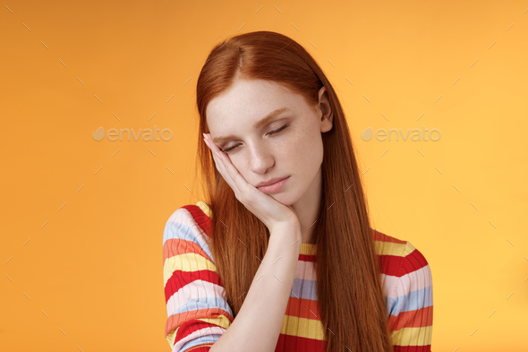 Tired cute redhead female student exhausted feel sleepy fall asleep standing leaning face palm close
