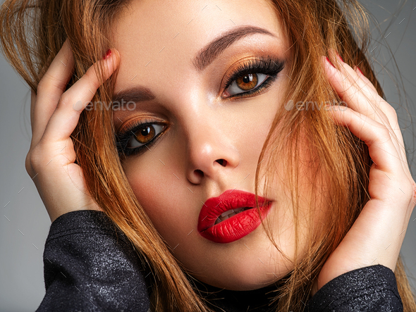 Beautiful girl with red lips and brown hair. Stock Photo by valuavitaly