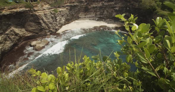 Truck Reveal Shot of Waves Crashing Ashore the Stunning Sandy Beach with Blue Sea and Steep Ocean alt