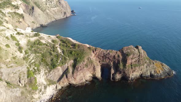 Aerial View From Above on Azure Sea and Volcanic Rocky Shores alt