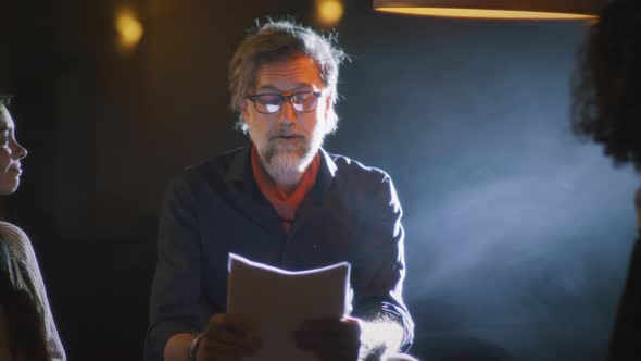 Actors and Director Discussing Script alt