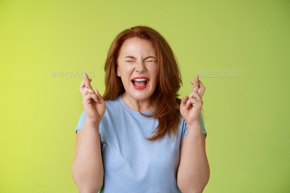 Woman wants win badly. Enthusiastic lucky redhead middle-aged 50s female pleading implore god make