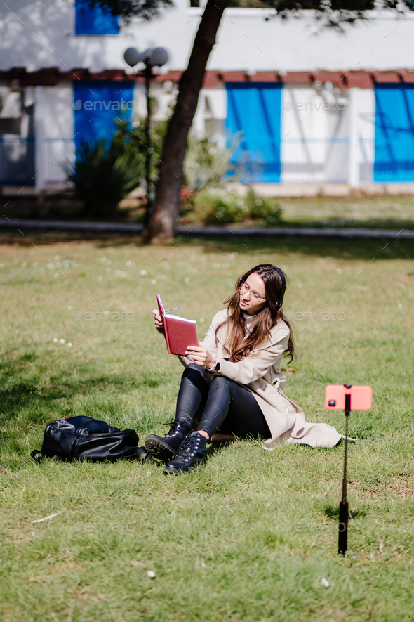 female student virtual learning on mobile internet outdoors