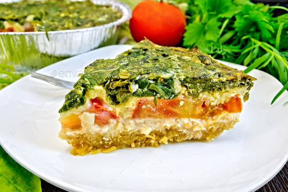 Pie celtic with spinach and tomatoes on board - Stock Photo - Images