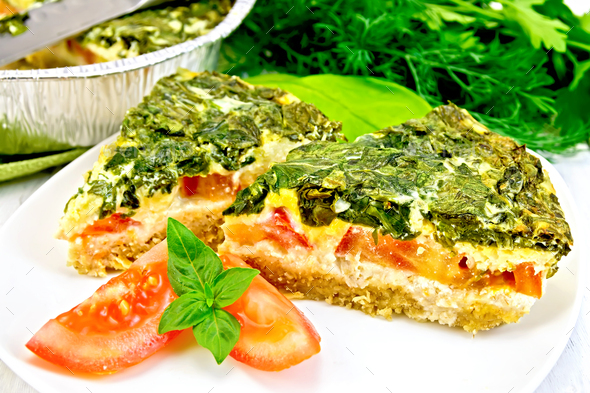 Pie celtic with spinach in plate on board - Stock Photo - Images