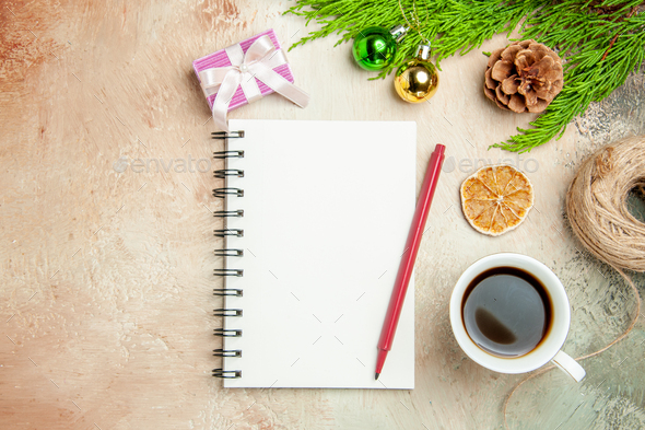 top view empty open notepad with tea and red pencil on light-white background copybook xmas new
