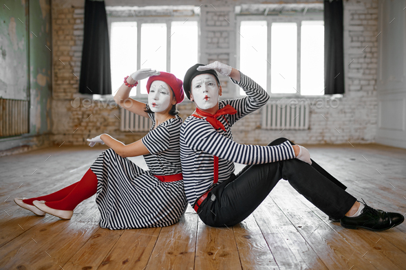 Male And Female Mime Artists Sitting On