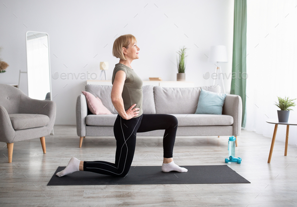 Attractive fit woman exercising in studio with copyspace