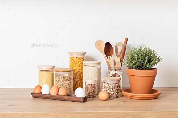 Organizing zero waste storage in kitchen. Pasta and cereals in reusable  glass containers in kitchen Stock Photo by OksaLy