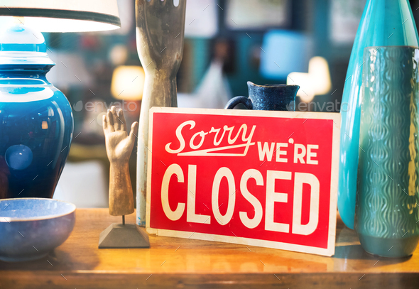 Red notice displayed in a store window - Sorry We're Closed - Stock Photo - Images