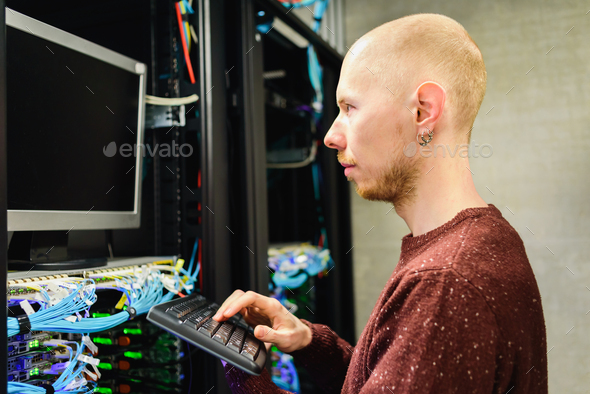 Man data center technician performing server maintenance