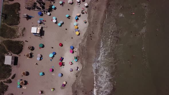 Aerial view of the beach in a hot summer morning, people having fun, enjoying the summer adventures. alt