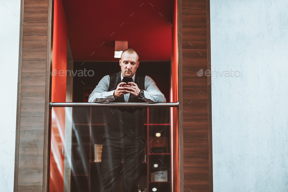 A businessman on an office balcony - Stock Photo - Images